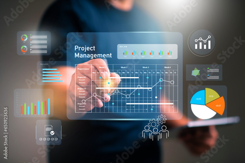 Project management concept, businessman working with schedule plan to manage work projects and update tasks. Work progress, project plan, efficient scheduling.