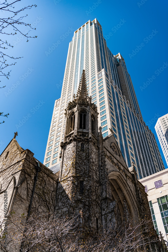 Fototapeta premium presbyterian church. gothic architecture of church with skyscraper on background. architectural design of the city. church and skyscraper