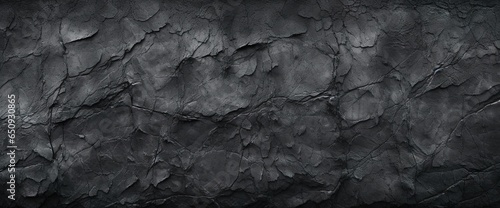 Black or dark gray rough grainy stone texture background © Vasilina FC