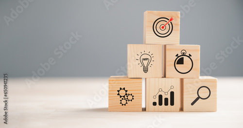 Action Plan, Goal, and Target icons on a wooden block cude step. Success and business target concept. Project management and company strategy symbolize progress. photo