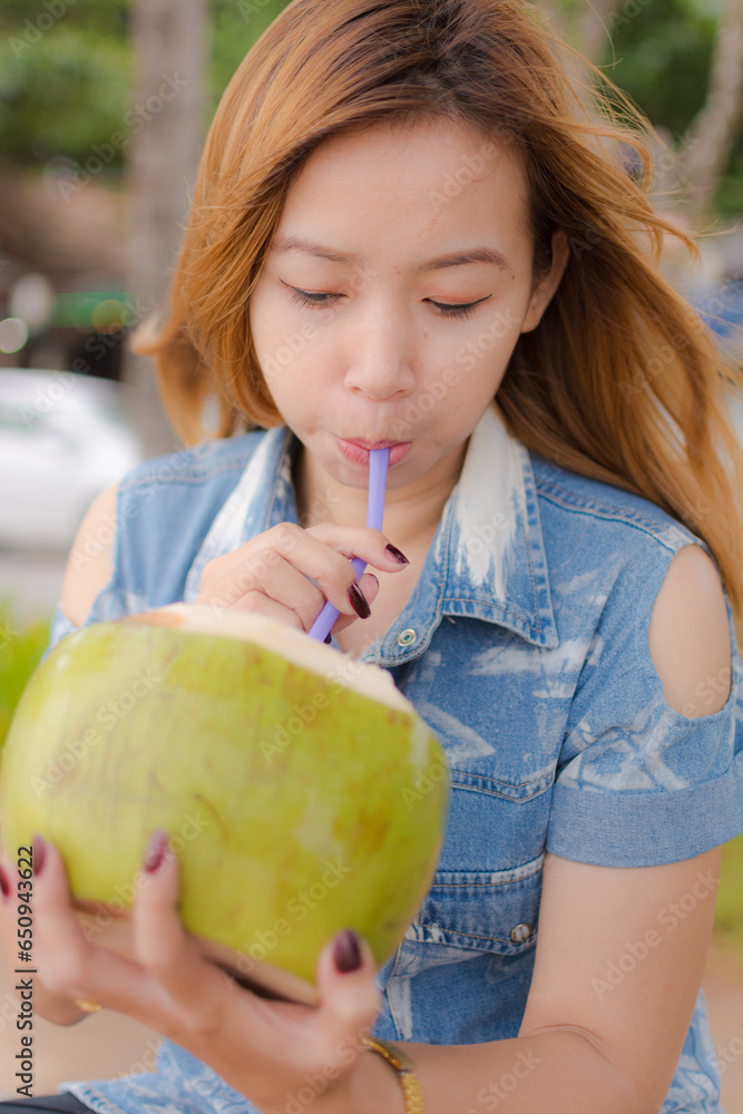 Fototapeta premium girl eating coconut.