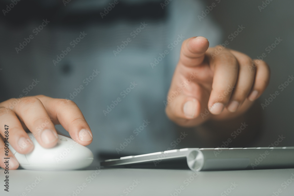 Businessman using computer mouse and pressing button on virtual screen. Man pointing.  - obrazy, fototapety, plakaty 