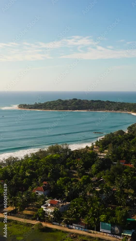 Panorama of the coastal resort town of Arugam bay, Sri Lanka. City beach and hotels. Vertical video. Panorama of the coastal resort town of Arugam bay, Sri Lanka. City beach and hotels. Vertical video.