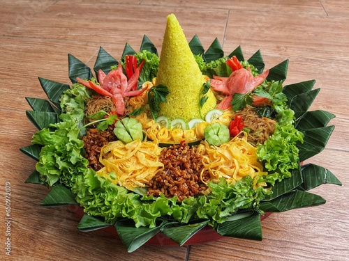 The Nasi Tumpeng contains beautifully decorated yellow rice with various side dishes
