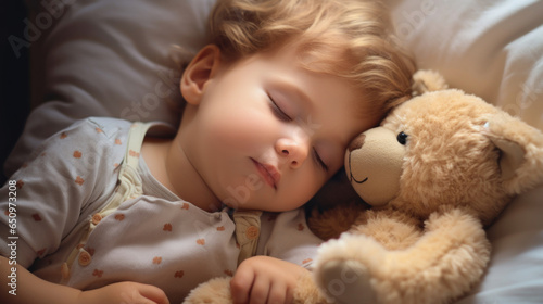 Sleeping baby with his teddy bear