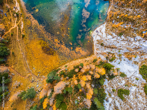 Autumn colors on Lake Federa. Dolomites from above