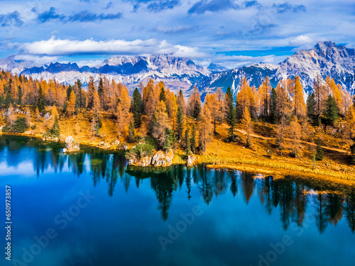Autumn colors on Lake Federa. Dolomites from above