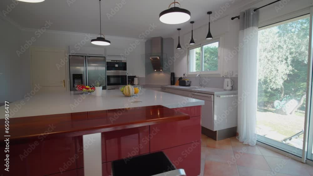 Slow establishing shot of a small modern white kitchen within a house Slow establishing shot of a small modern white kitchen within a house