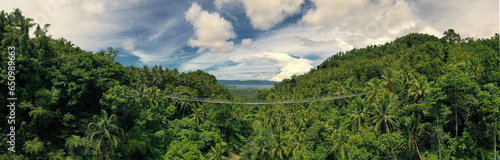 Aerial panorama overlooking Lumondo Hanging Bridge and Lake Mainit the largest lake in Northern Mindanao. Philippines 