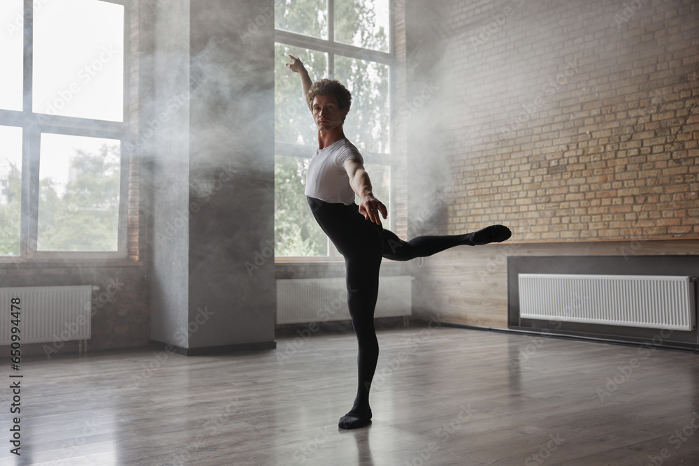 Confidence male ballet dancer practicing alone in studio room Confidence male ballet dancer practicing alone in studio room