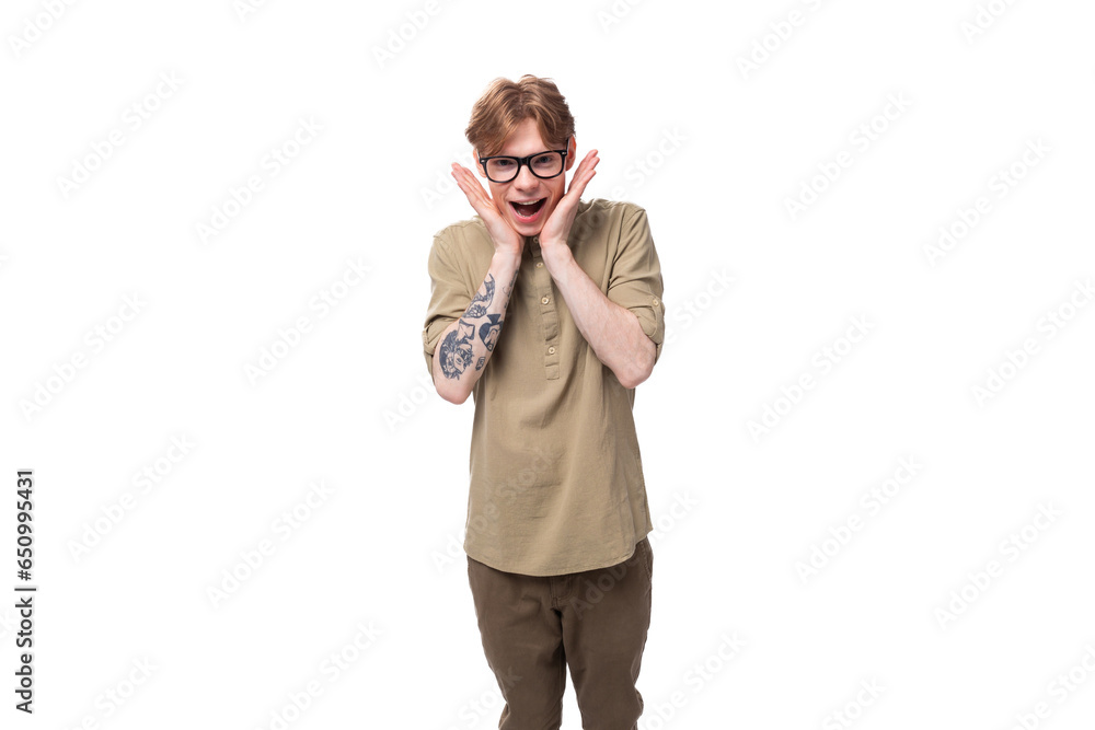 young shocked surprised redhead caucasian guy dressed in khaki short sleeve shirt young shocked surprised redhead caucasian guy dressed in khaki short sleeve shirt