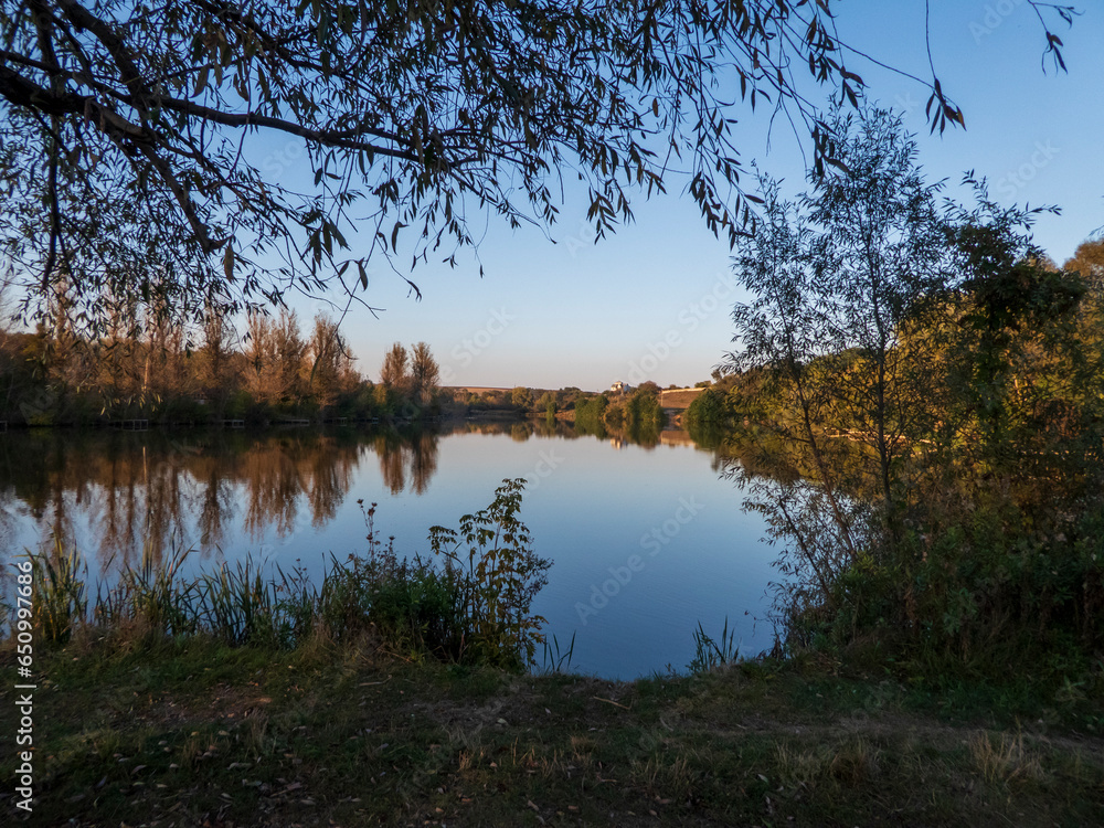 photograph of a river bank in early autumn