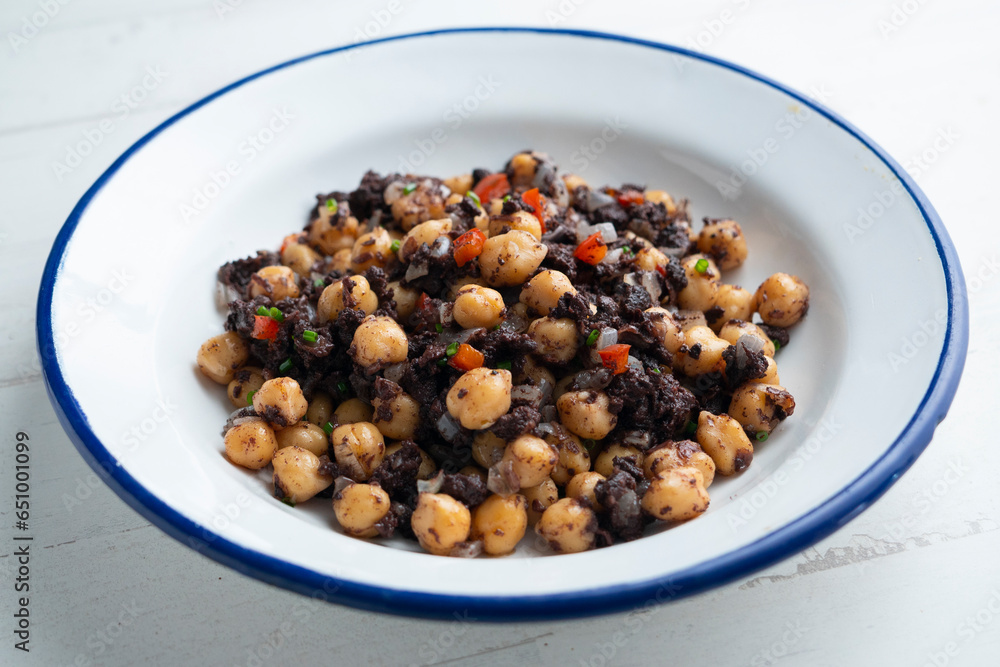Stewed chickpeas with black pudding and red pepper. Traditional tapas from Barcelona. Stewed chickpeas with black pudding and red pepper. Traditional tapas from Barcelona.