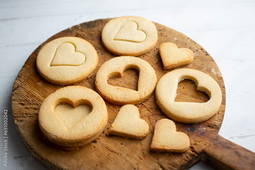 Preparing butter cookies for children with star and heart shapes.