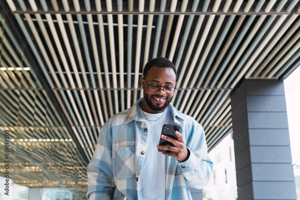 Young African American man smiling confident using smartphone at street Young African American man smiling confident using smartphone at street