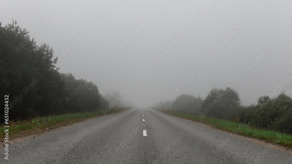Fog in the morning on a highway in a rural area- vintage photography look