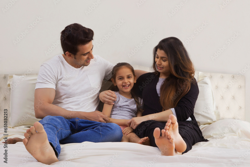 Portrait of family with daughter in bedroom Portrait of family with daughter in bedroom