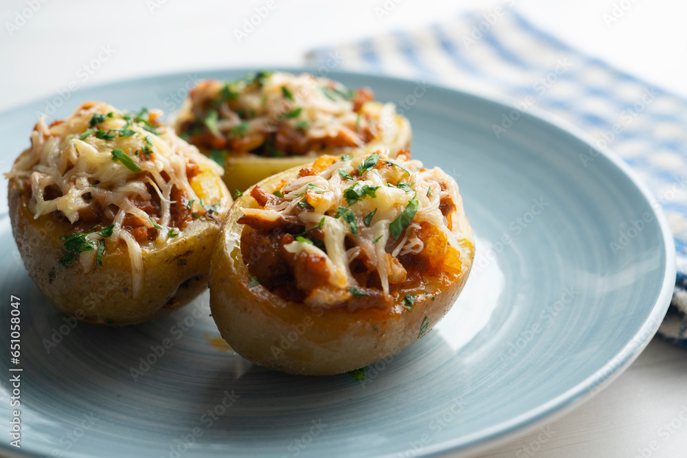 Potatoes stuffed with minced meat and tomato and baked in the oven with cheese. Potatoes stuffed with minced meat and tomato and baked in the oven with cheese.