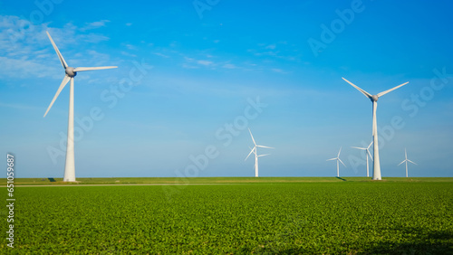windmill park with clouds and a blue sky, wind mill turbines in the Netherlands