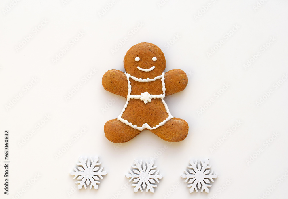 Fotografie Gingerbread man on a white background with snowflakes