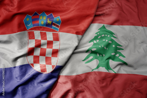 big waving national colorful flag of croatia and national flag of lebanon . photo