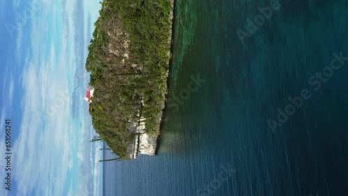 Chapelle Notre Dame de Lourdes on island of Lifou, vertical aerial dolly forward. photo