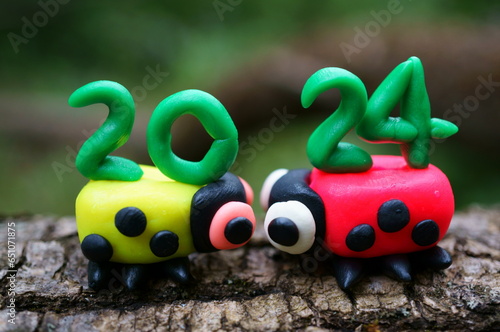 Two ladybugs and the number 2024. A festive event. Calendar date.