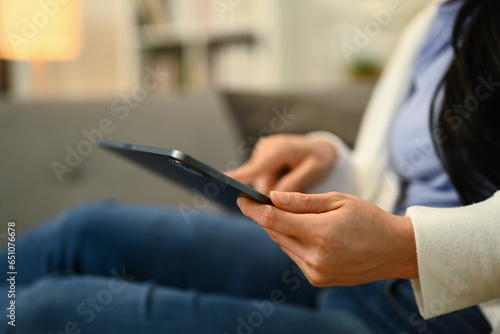 Young woman hand typing on digital tablet, surfing social media or checking email. People, technology and lifestyle