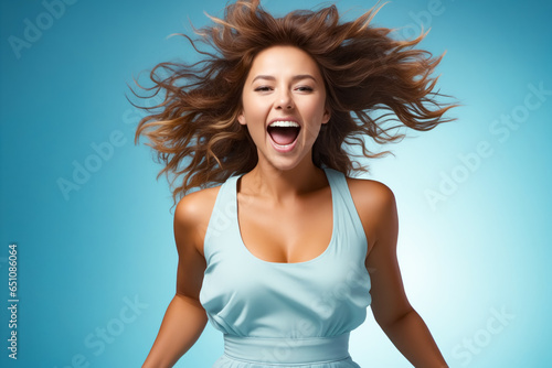 Woman with her hair in the air and her eyes closed.