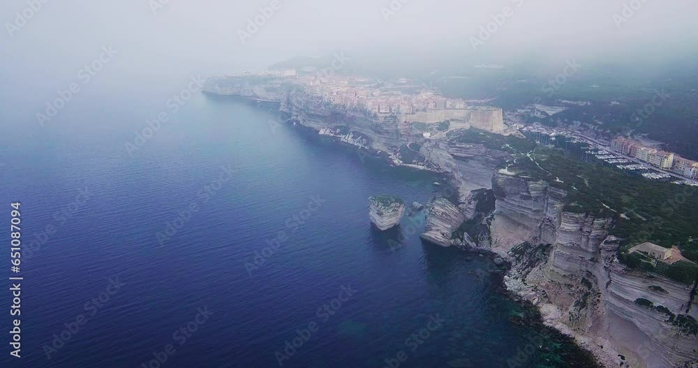 Bonifacio Town & Harbor with fog, 4K drone aerial, Mediterranean Corsica Island, France Bonifacio Town & Harbor with fog, 4K drone aerial, Mediterranean Corsica Island, France