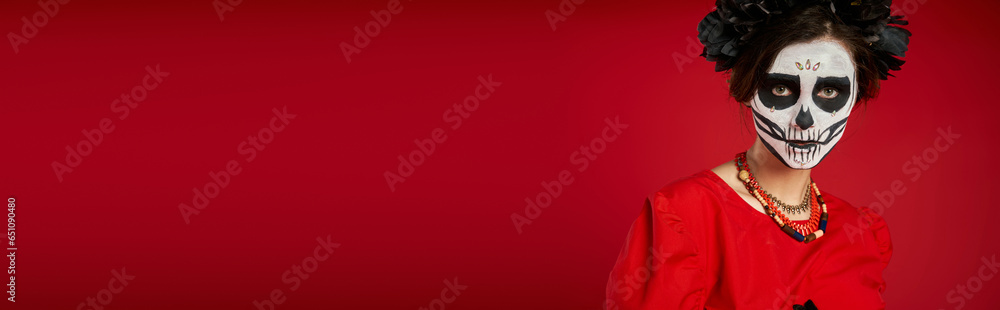 portrait of scary woman in traditional dia de los muertos makeup and colorful beads on red, banner portrait of scary woman in traditional dia de los muertos makeup and colorful beads on red, banner