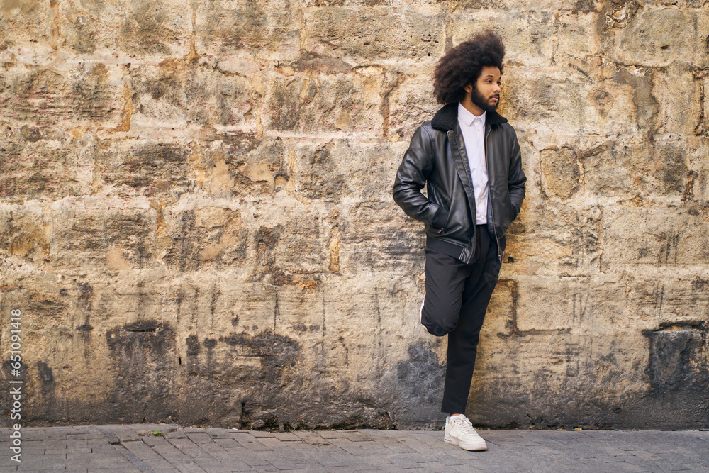 Portrait of a young Afro with hands in pockets Portrait of a young Afro with hands in pockets