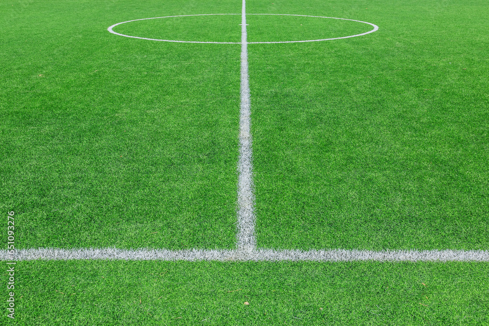 Green synthetic grass sports field with white line shot from above. background Green synthetic grass sports field with white line shot from above. background