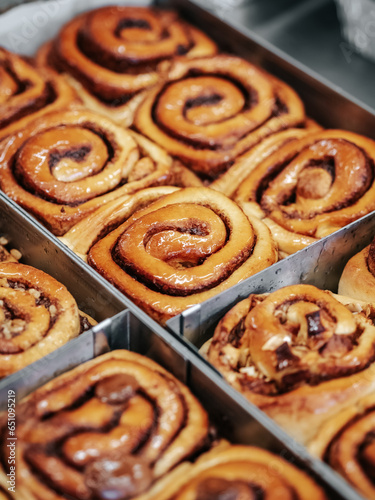 A cinnamon rolls (cinnamon bun, cinnamon swirl, cinnamon snail) close up. Fresh pastries in the bakery