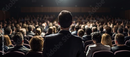Unidentified audience member at business and entrepreneurship event watching speaker