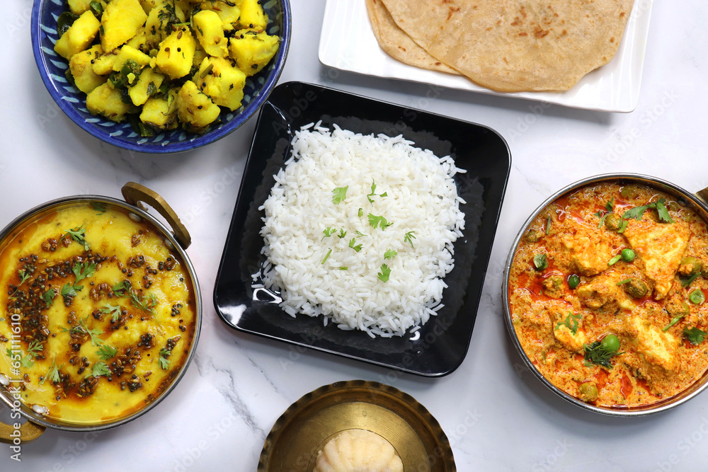 Rice Roti Plate Indian vegetarian Thali or platter includes Aloo ki sabji, dal rice ...