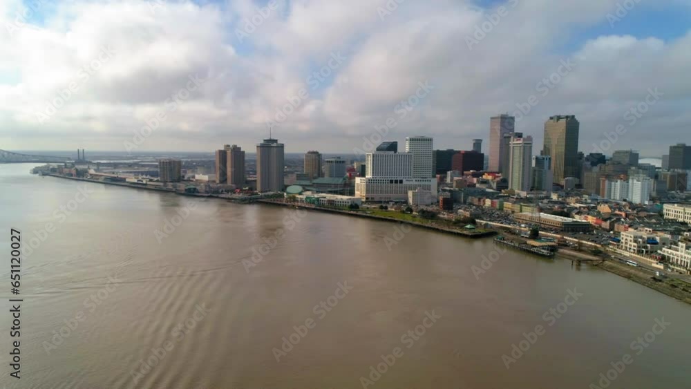 Aerial Panning Shot Of Crescent City Connection Over River In City Against Sky - New Orleans, Louisiana Aerial Panning Shot Of Crescent City Connection Over River In City Against Sky - New Orleans, Louisiana