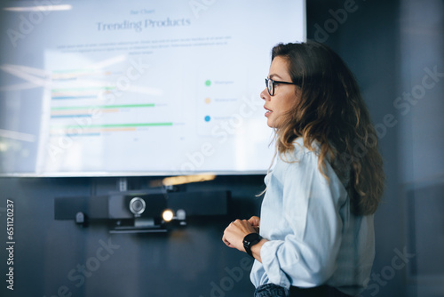 Product manager presenting a report on trending products in a business meeting photo