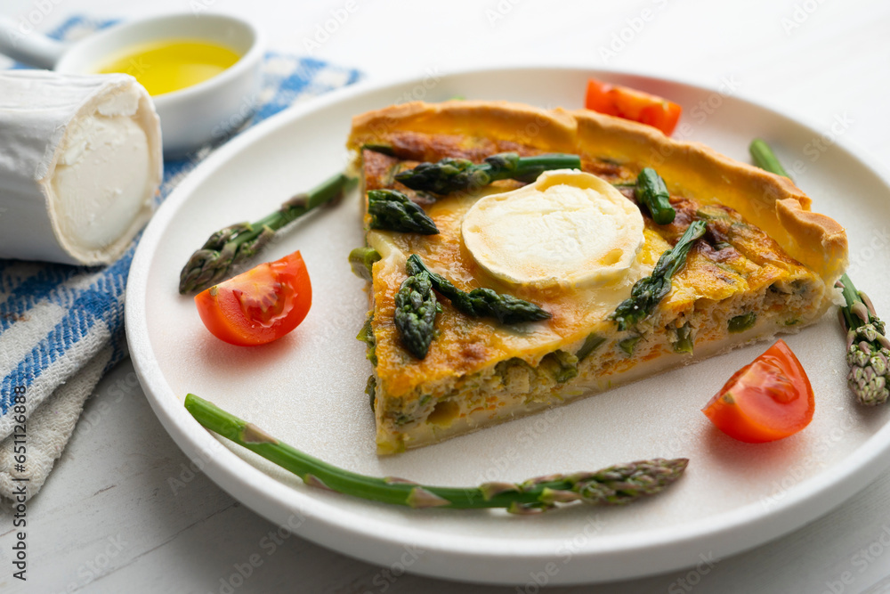 French style quiche with green asparagus, eggs, and slices of goat cheese. French style quiche with green asparagus, eggs, and slices of goat cheese.