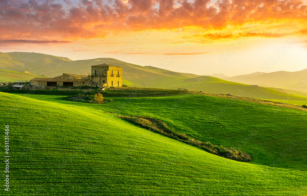 sceniv view at a nice farm in green fields in hills and highlands, landscape of spring green hills with mountain bright sunset on backdrop sceniv view at a nice farm in green fields in hills and highlands, landscape of spring green hills with mountain bright sunset on backdrop