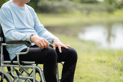 Elderly patient sitting in a wheelchair outdoor.