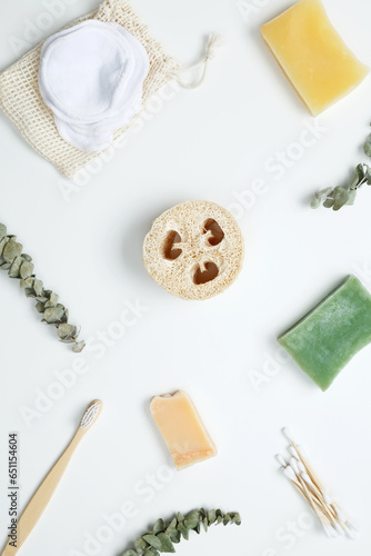 Natural organic eco cosmetics. Soap Eco, reusable cotton pads, loofah natural sponge washcloth, cotton swab, eucalyptus leaves on white background. Flat lay, top view