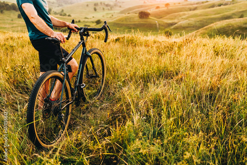 Mountain biker cycling a bike during a sunset outside. Healthy lifestyle and outdoor adventure concept