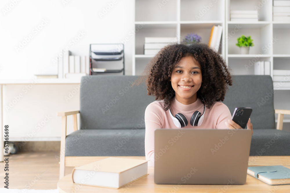 Young African woman studying online with laptop in coffee shop Millennial African American girl with headset working on laptop in coffee shop Young African woman studying online with laptop in coffee shop Millennial African American girl with headset working on laptop in coffee shop