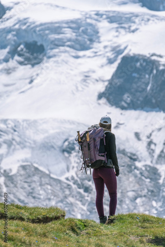 Young women embark on a thrilling alpine adventure, scaling the Swiss Alps, surrounded by awe-inspiring peaks and pristine wilderness.