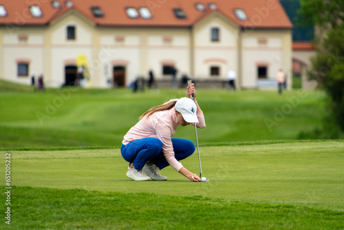 Young women gracefully golfing on a serene course, enjoying a sunny day filled with leisure and sport, perfectly capturing the essence of outdoor recreation.