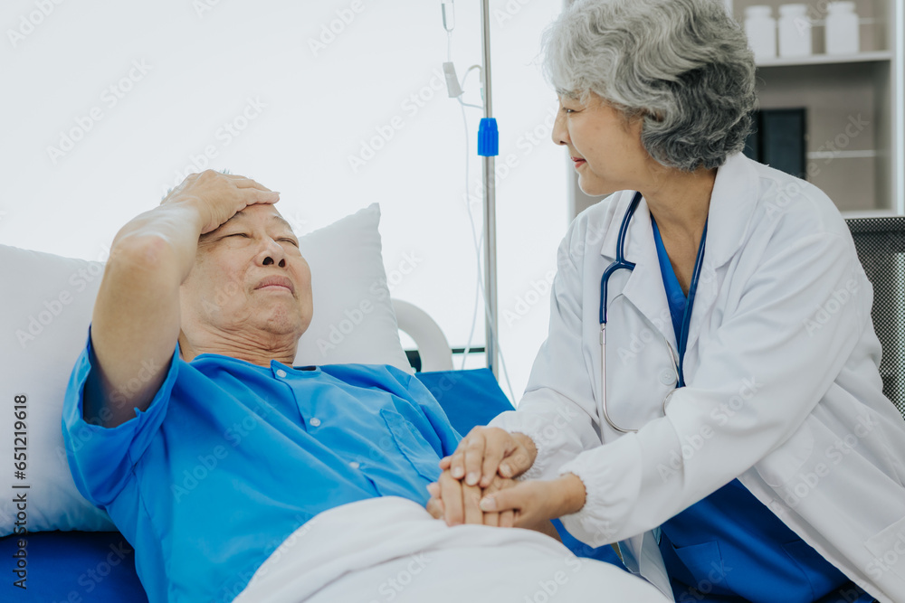 Asian female doctor caring for elderly male patient Elderly patient care and health lifestyle, medical concept Asian female doctor caring for elderly male patient Elderly patient care and health lifestyle, medical concept