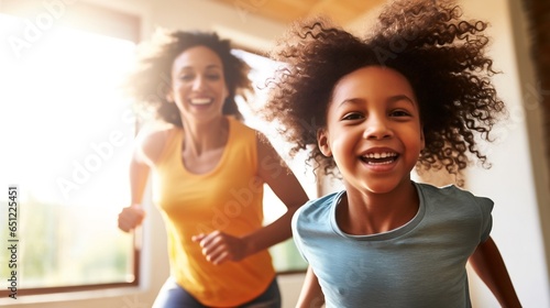 Mother and daughter are running around the house and fooling around. photo