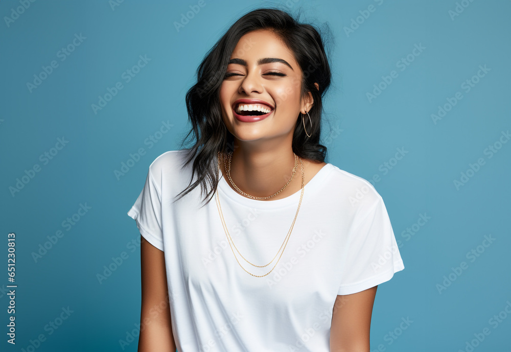 Portrait of a smiling woman with white tshirt. blue background Portrait of a smiling woman with white tshirt. blue background