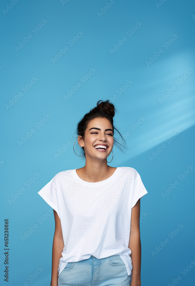 Portrait of a smiling woman with white tshirt. blue background Portrait of a smiling woman with white tshirt. blue background